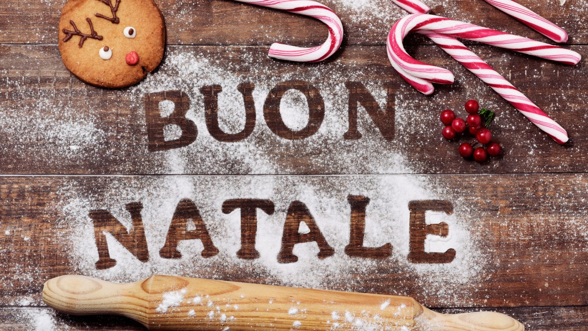Christmas in Italy: A wooden board with ‘Buon Natale’ written on it and traditional Christmas food